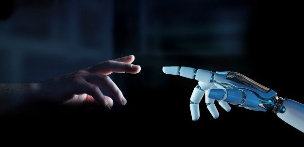 Tangan manusia dan tangan robot saling mendekat, melambangkan hubungan antara manusia dan kecerdasan buatan di era singularitas teknologi.
